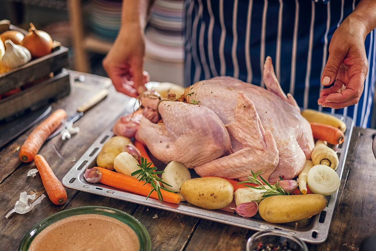reparing stuffed turkey with vegetables and other ingredients for holidays