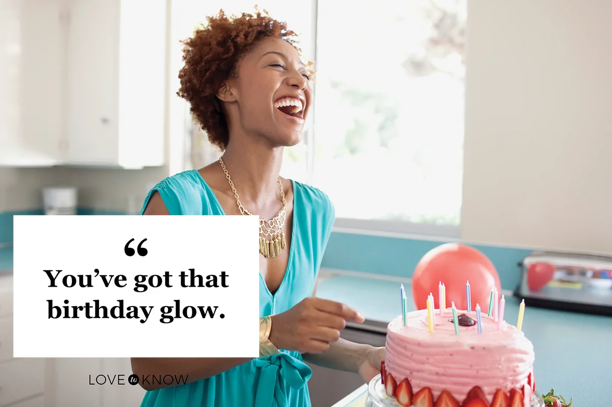 Laughing woman preparing birthday cake