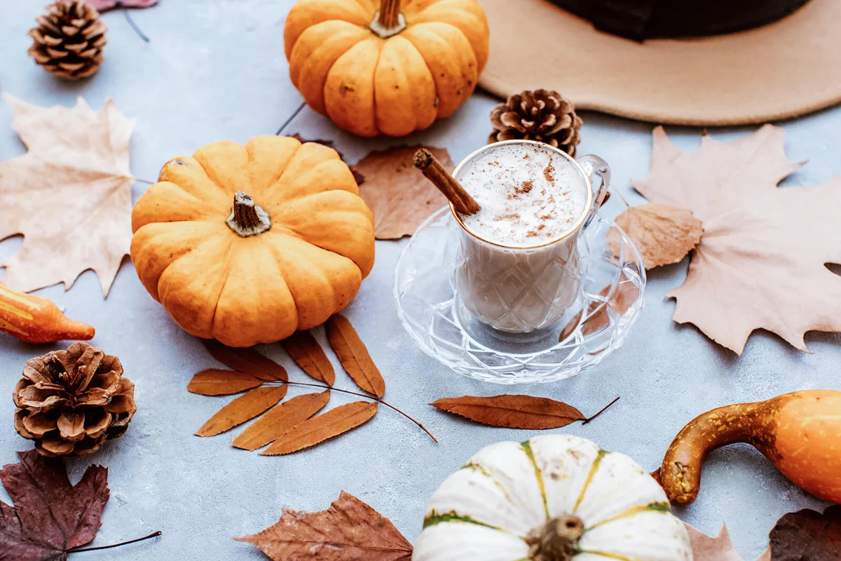 Cup of Pumpkin Spice Latte and Fall Decor from fresh pumpkins