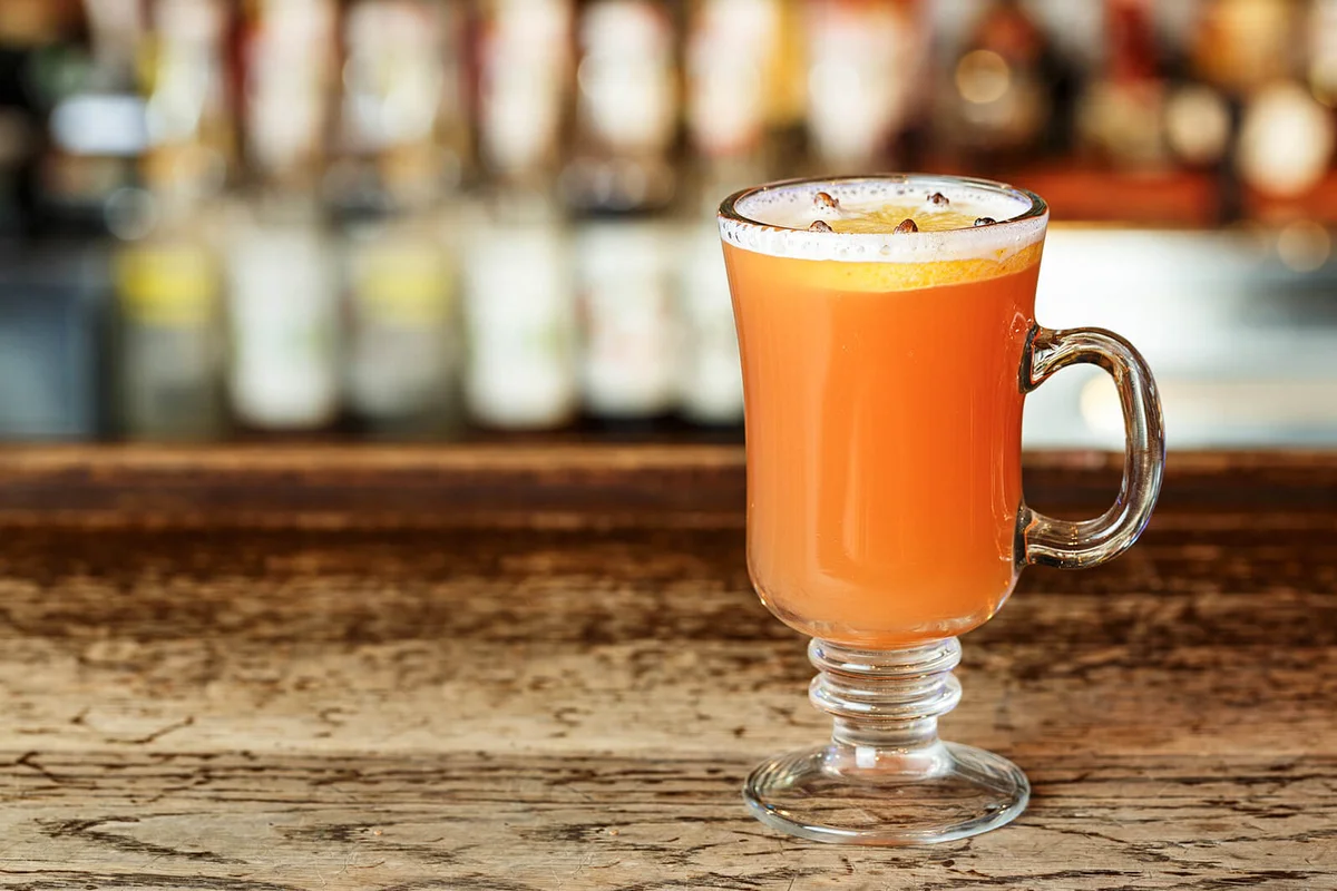 Hot alcoholic grog with orange and seasoning cloves