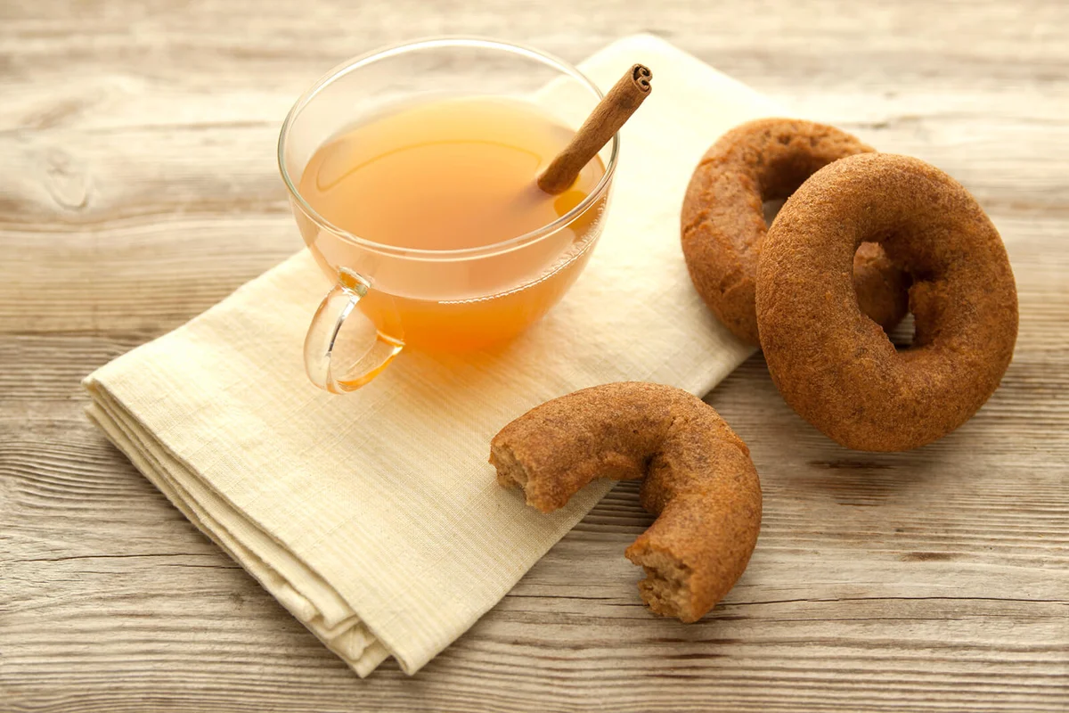 Hot Apple cider in a transparent cup with a cinnamon stick