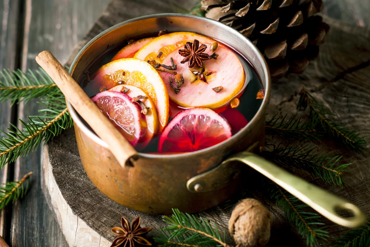 Gluhwein wine with oranges and cinnamon in a saucepan