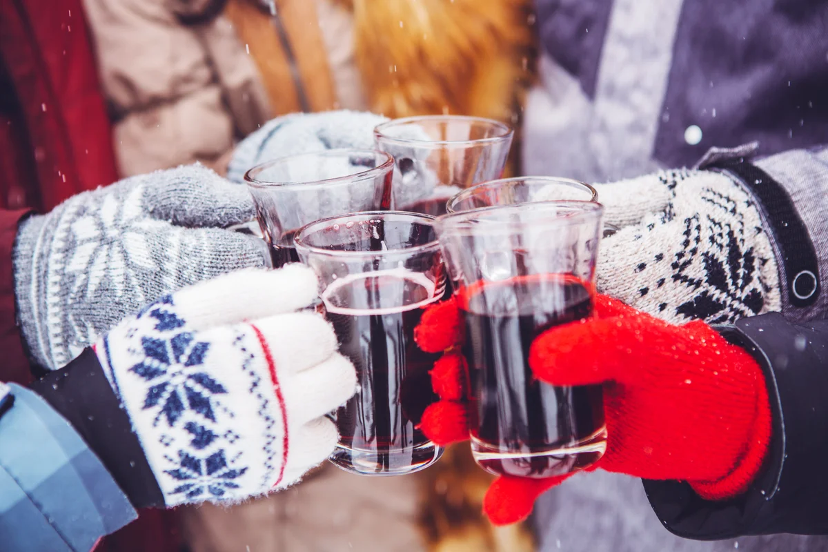 People holding mulled wine and enjoying winter