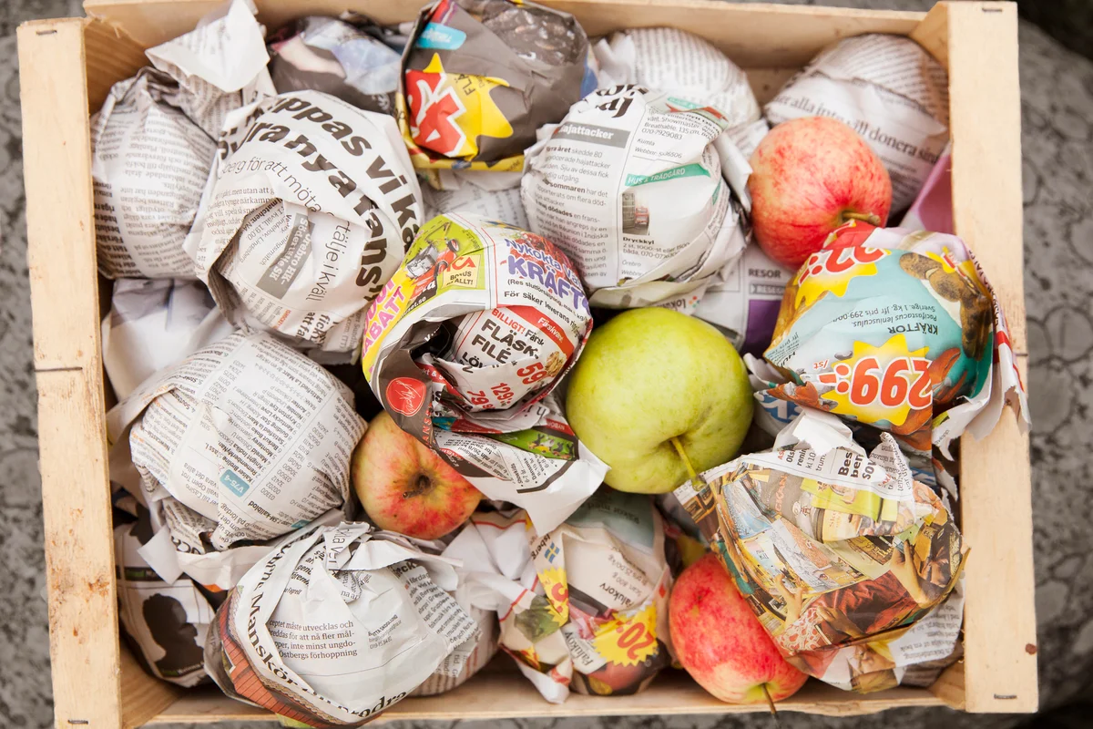 Apples wrapped in newspaper