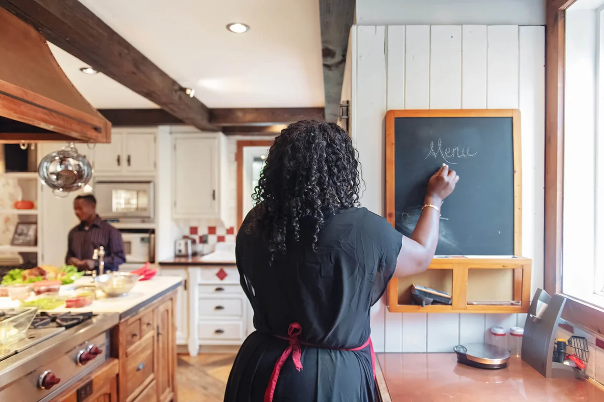 woman writing the thanksgiving menu