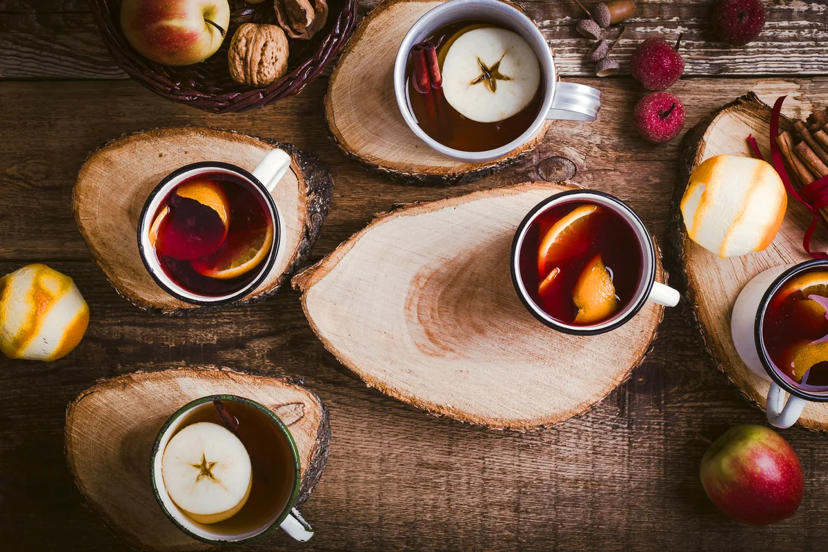 Hot drinks in rural mugs on wood slab coasters