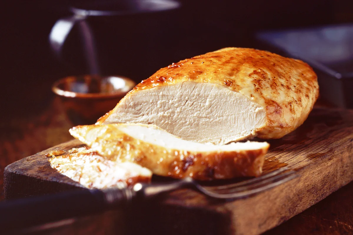 Roast turkey breast on rustic wooden chopping board
