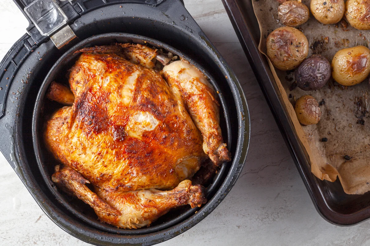 A whole chicken cooked inside an air frier