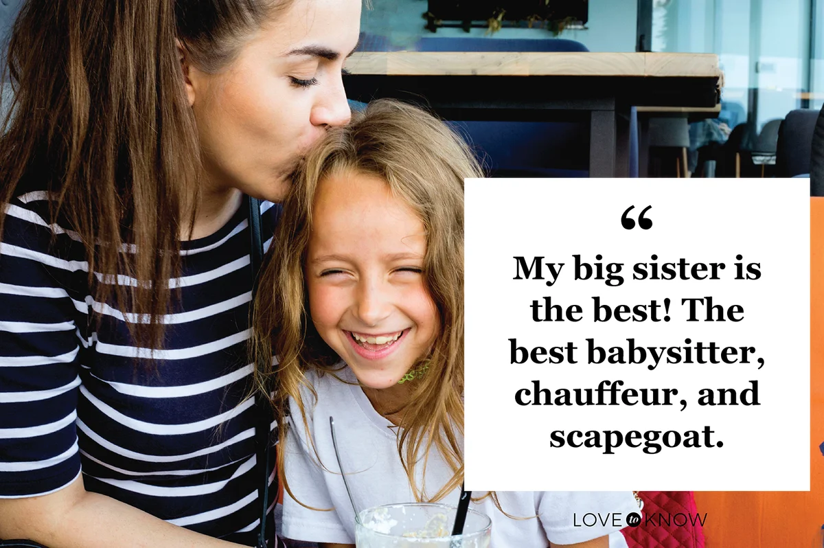 Loving supportive older sister kissing little one