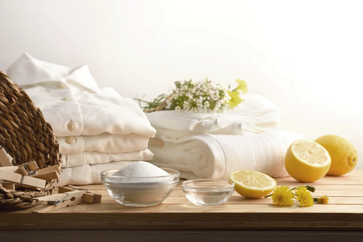 Alternative clothes cleaning products on table with clean white shirts
