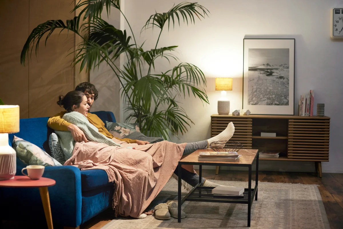 Couple talking while sitting on the couch in the living room