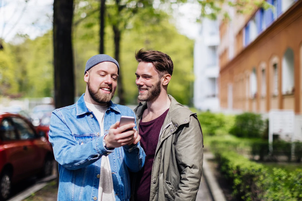 Gay couple looking at Map smartphone