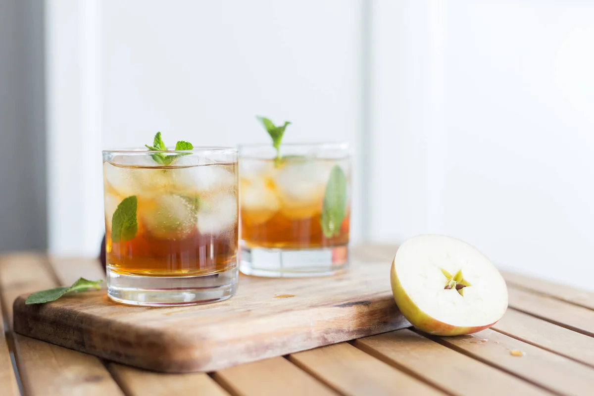 ice apple juice at wooden background