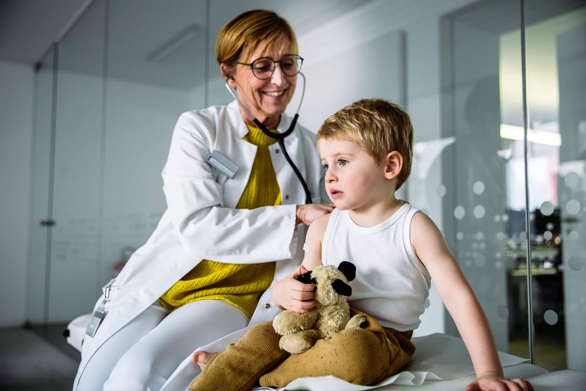 Doctor examining toddler boy with a stethoscope