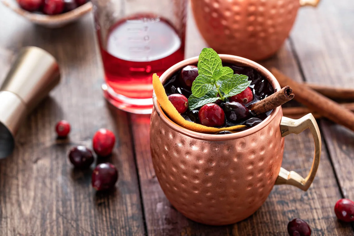 Cranberry orange moscow mule cocktail in copper mugs