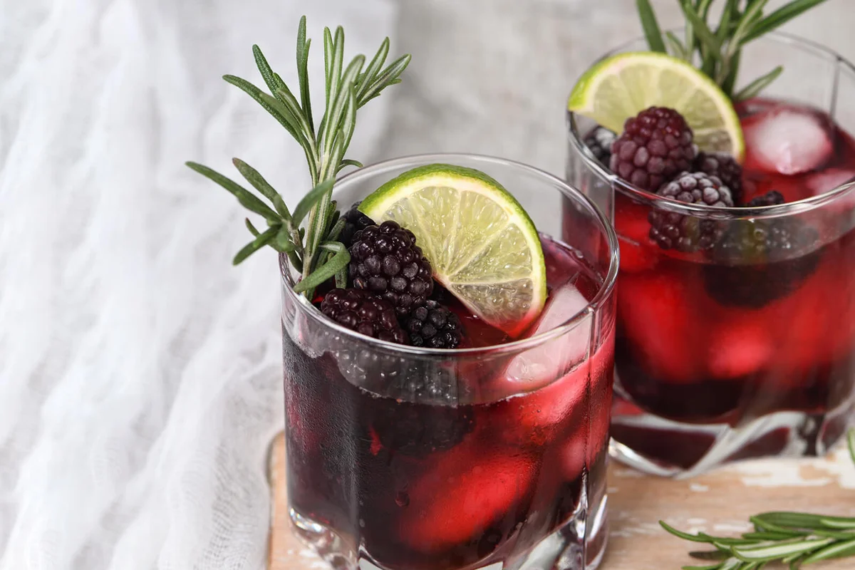 Two glasses of delicious refreshing lemonade with blackberry