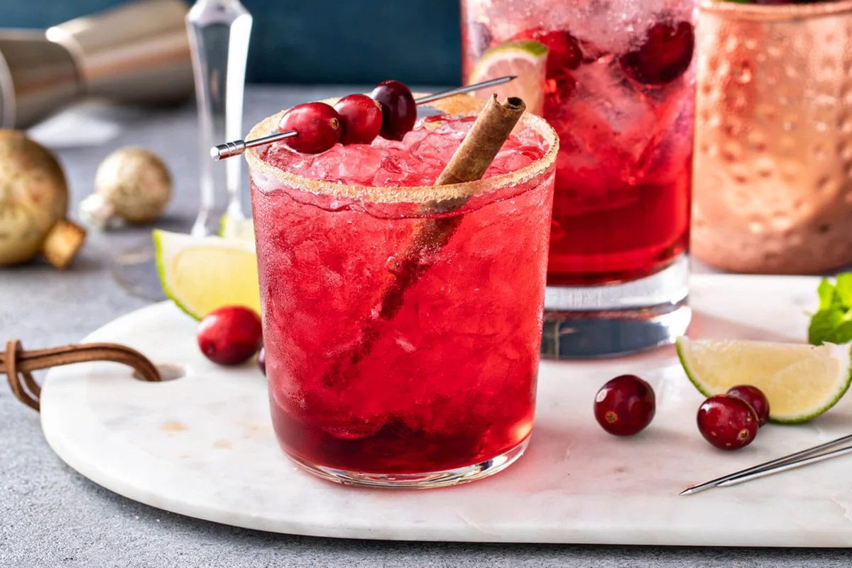 Variety of festive Christmas cocktails with cranberry and lime