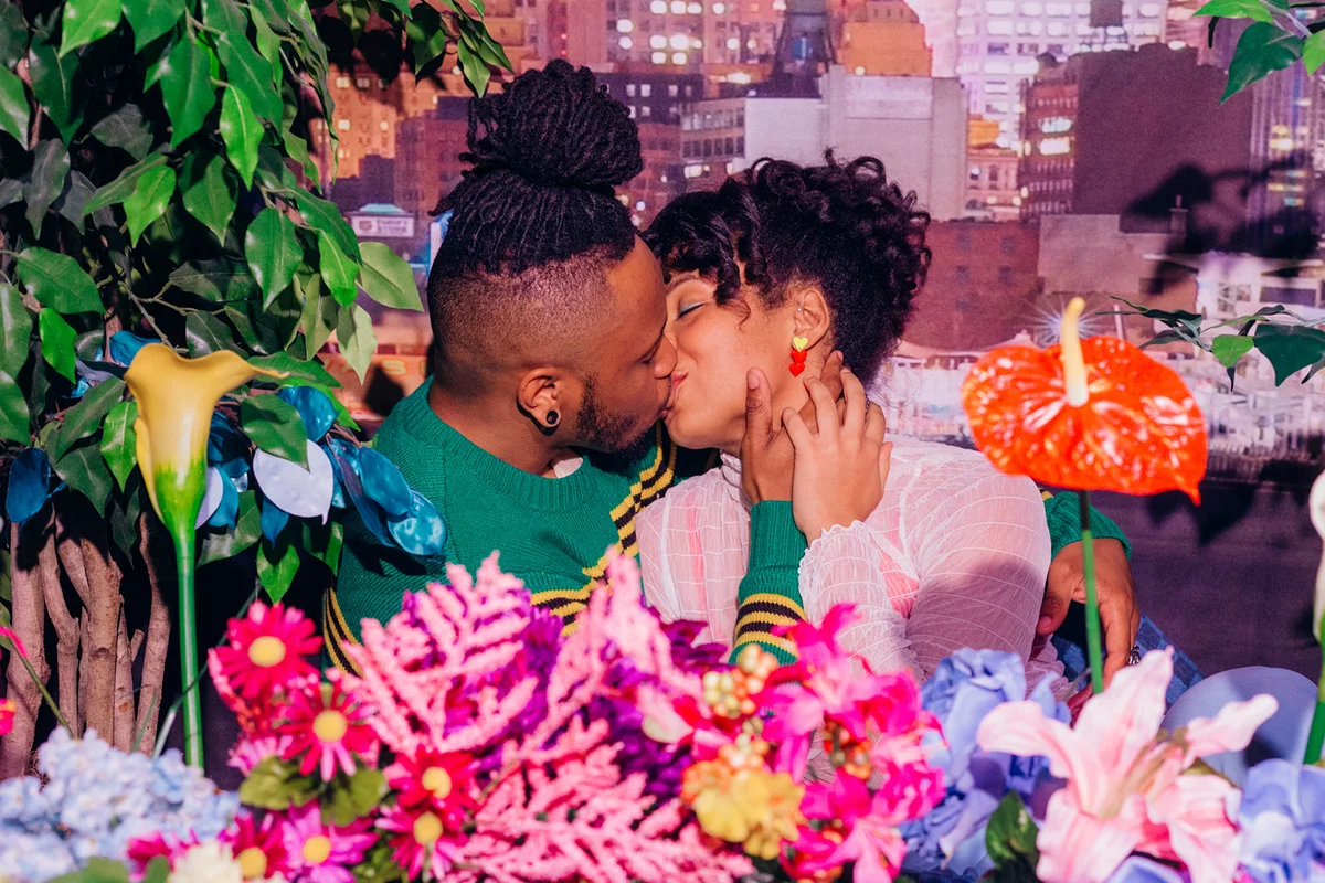 Young Couple Kissing surrounded by flowers