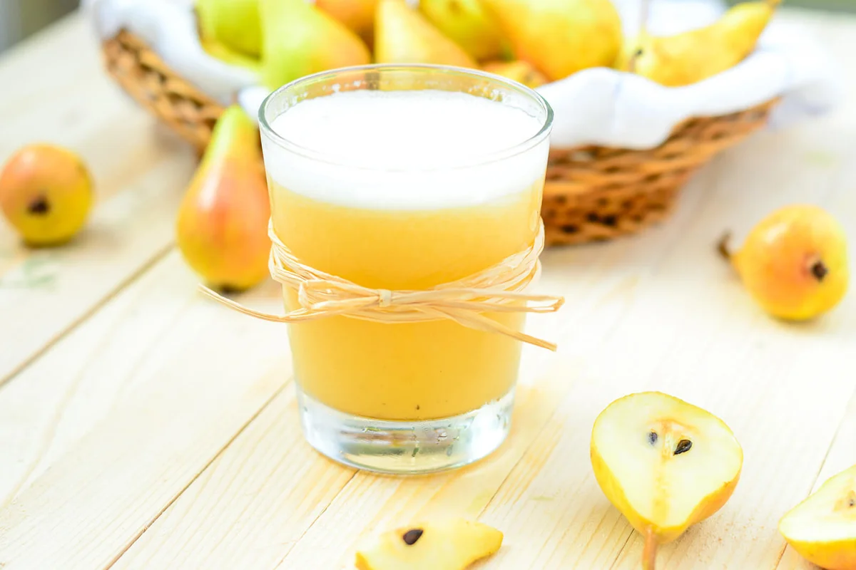 Pear Juice with fresh fruits on wooden boards