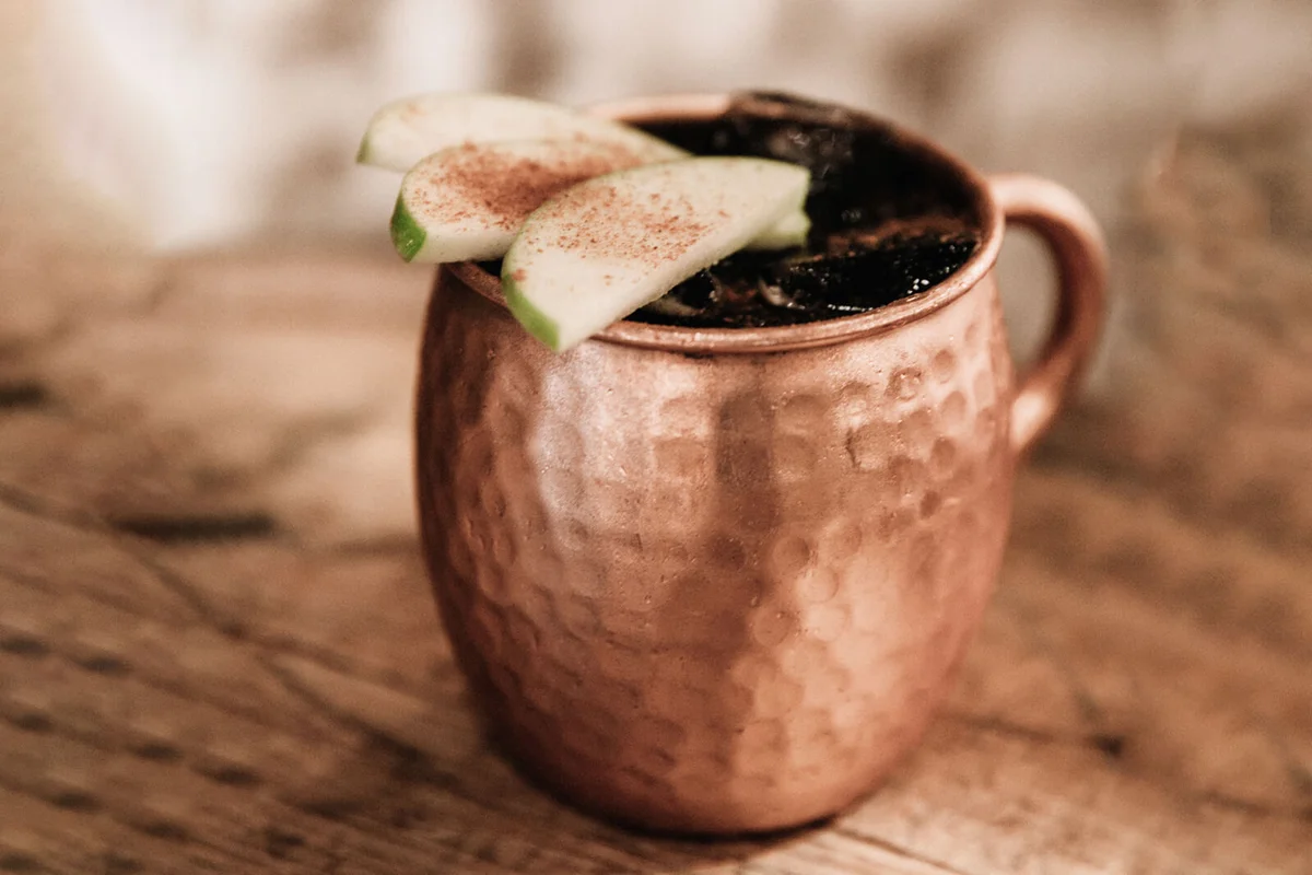 Moscow Mule cocktail garnished with apples and cinnamon | Photo 104370075 © Tisaeff | Dreamstime.com