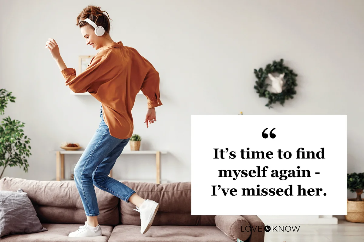 Cheerful woman listening to music and dancing on soft