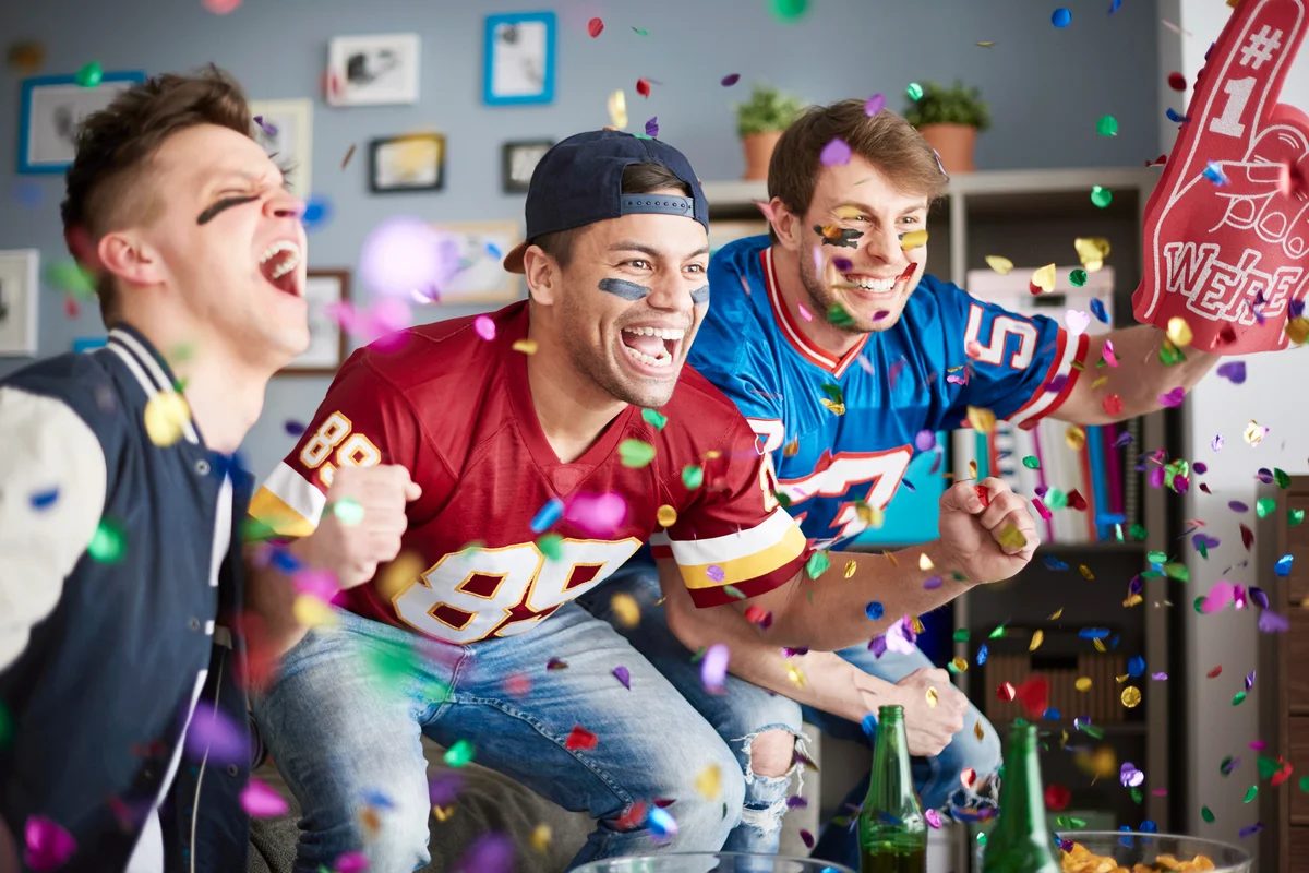 American football fans among falling confetti