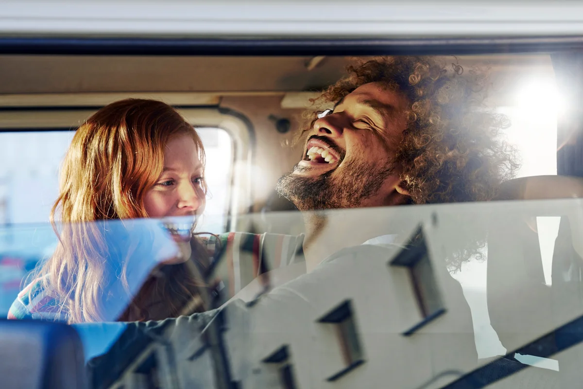 Happy young couple in a car