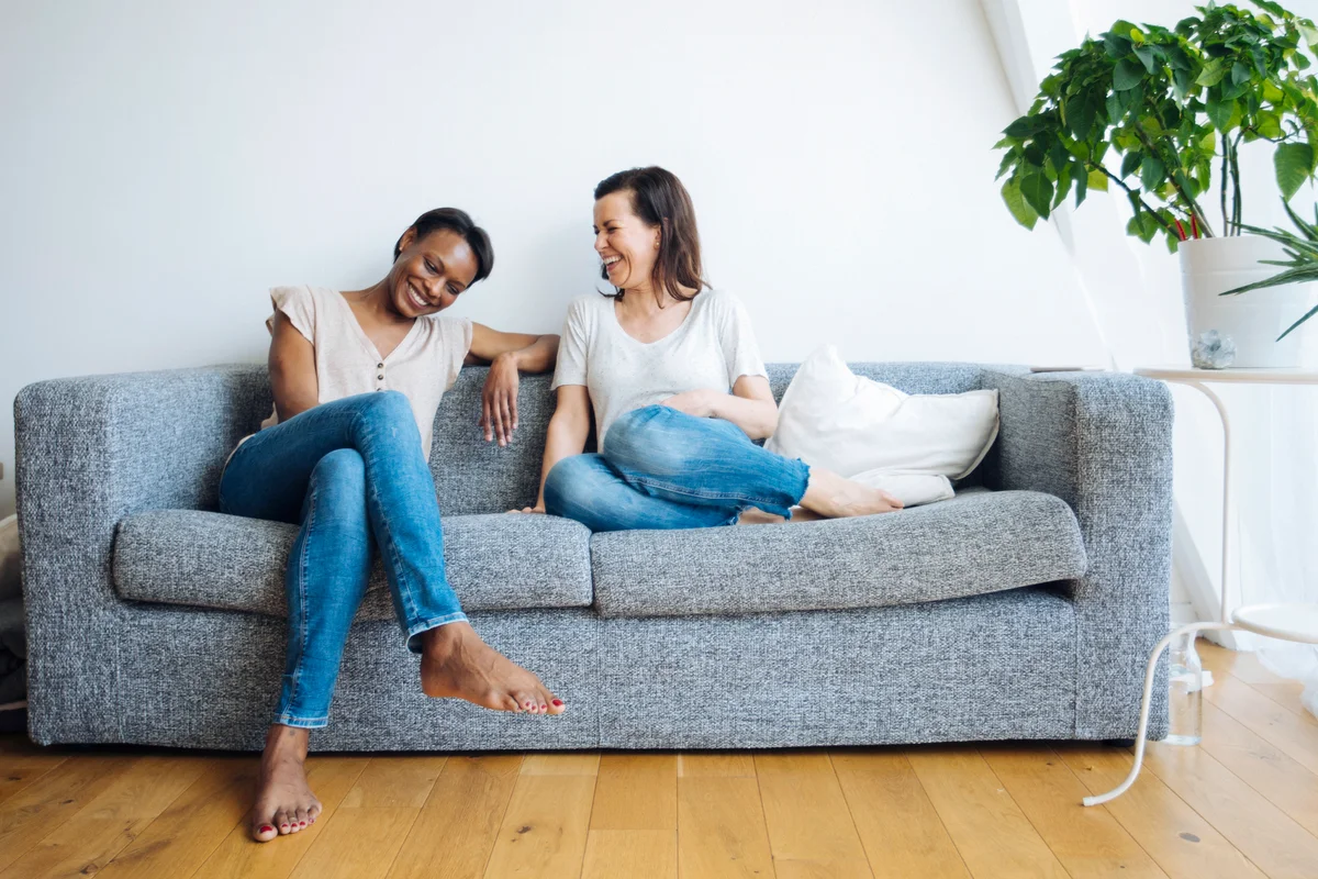 Happy couple relaxed and sitting on couch at home