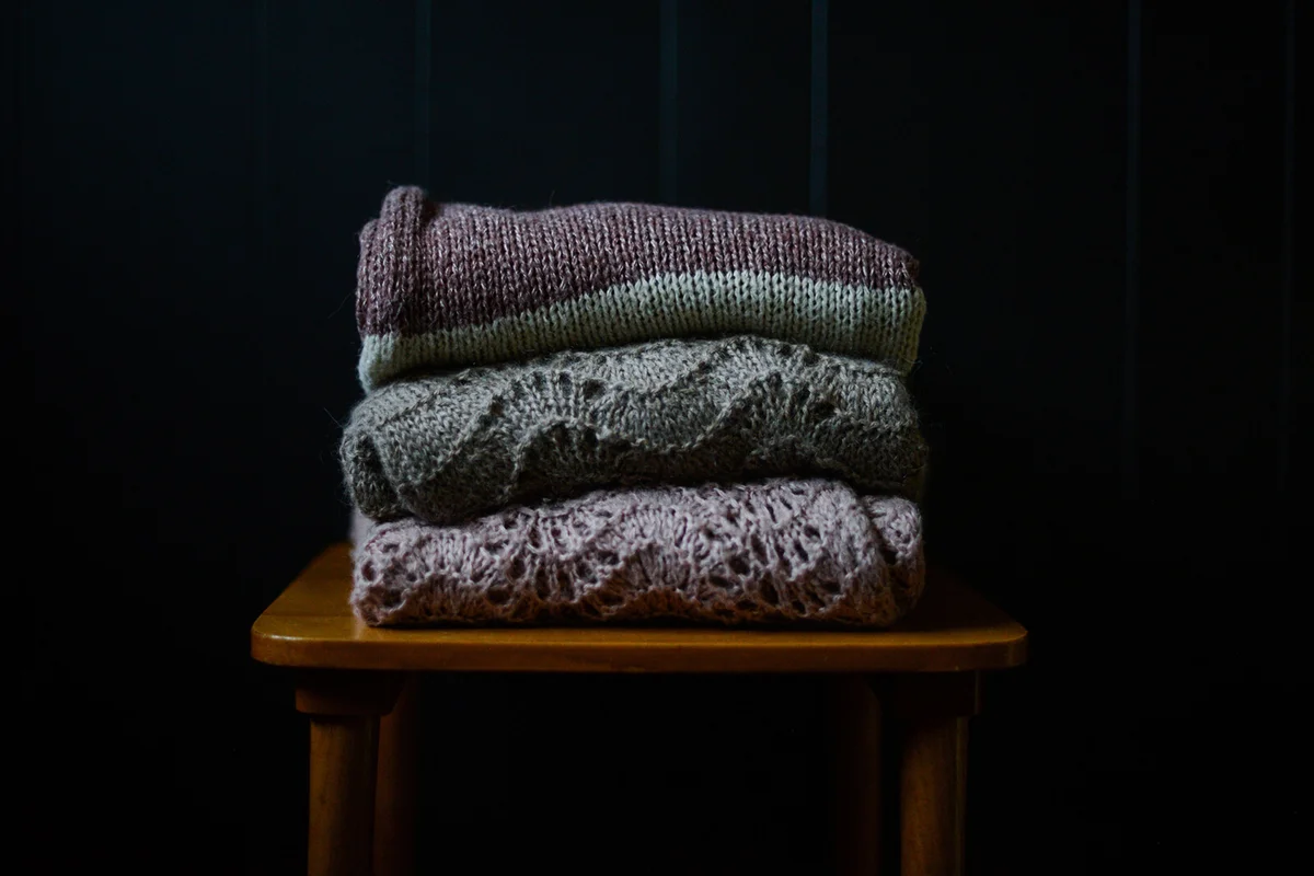 A stack of knitted sweaters
