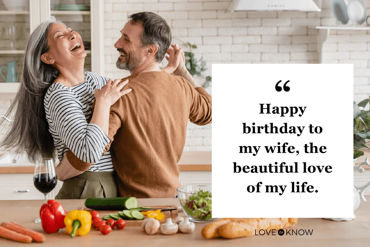 couple dancing together in the kitchen