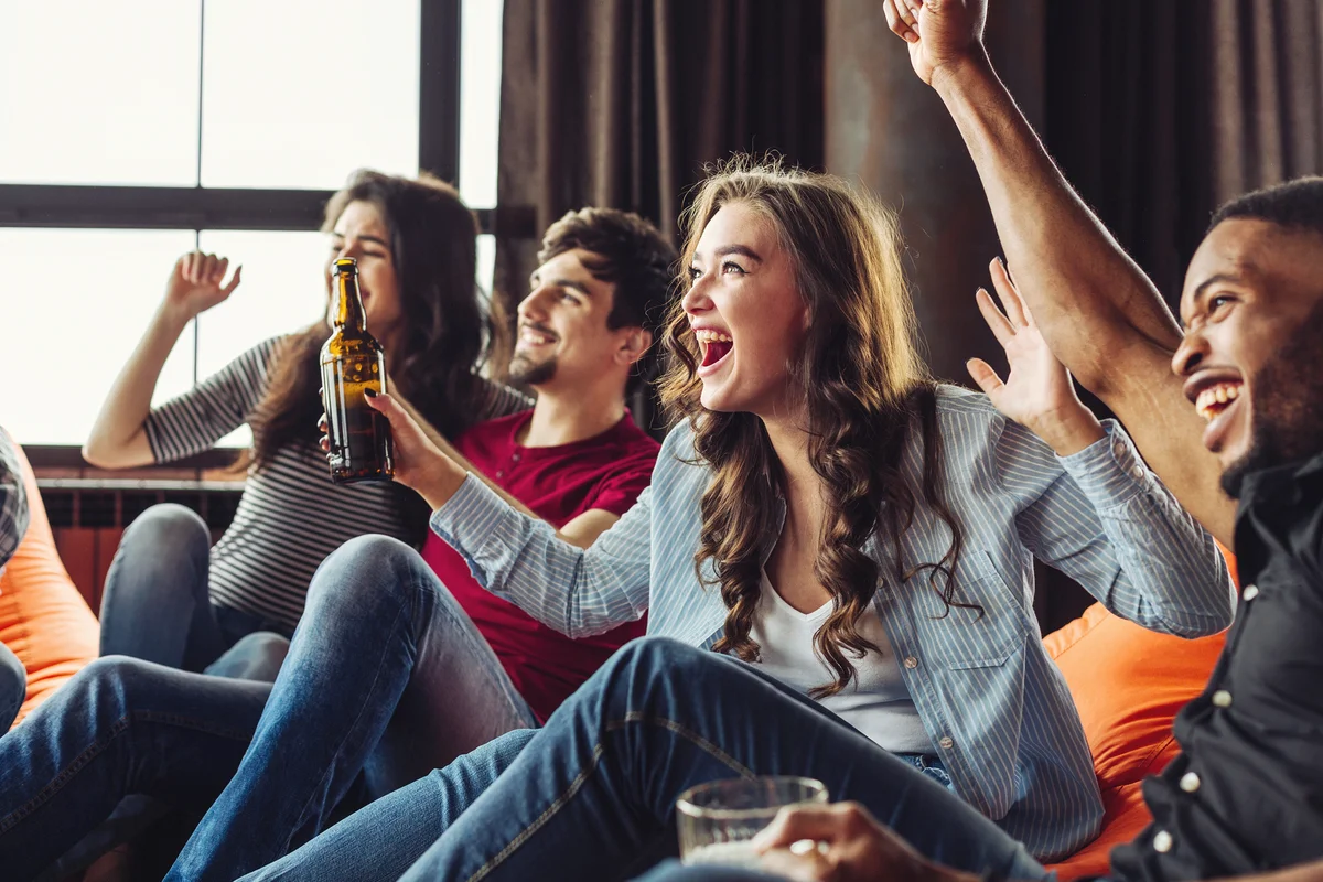 Happy friends have a party watching football match