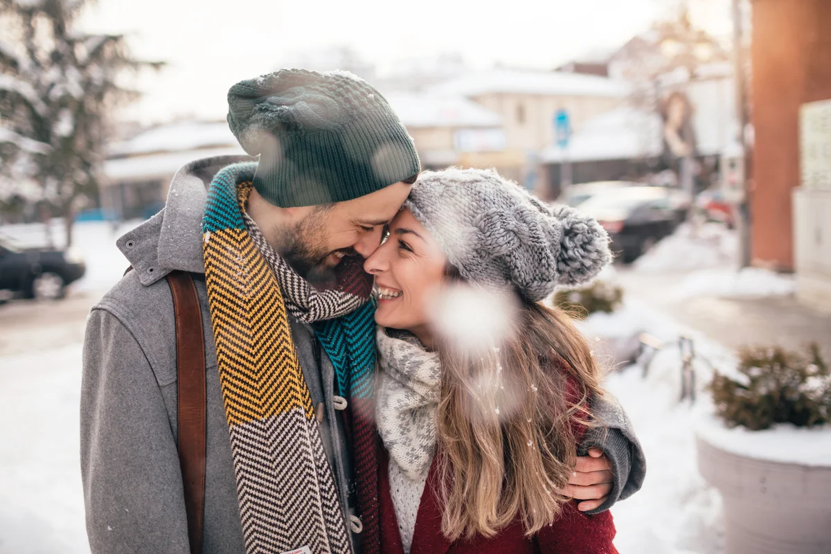 Beautiful couple having a winter walk in their city