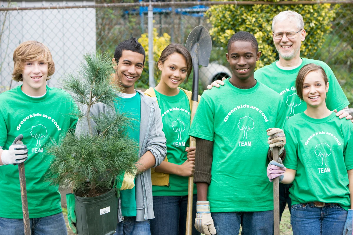 Volunteers planting a tree together