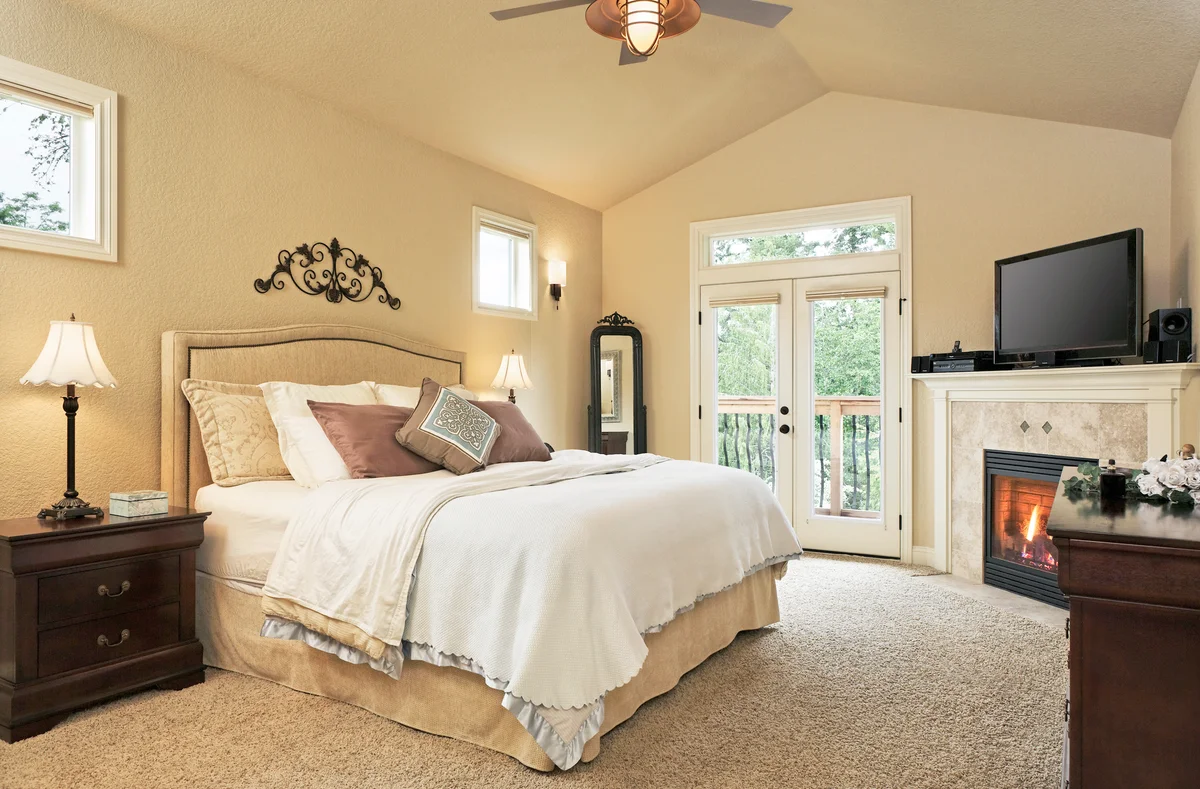 Beige master bedroom with fireplace