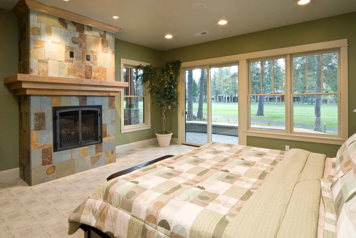 Modern master bedroom with tiled fireplace