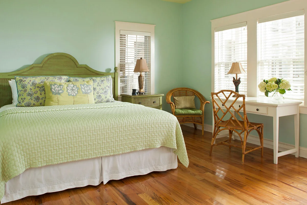 Blue-green bedroom with wood floors