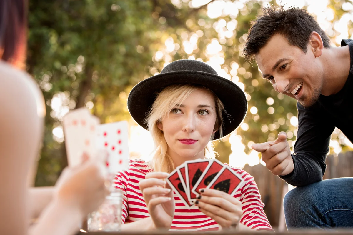 Friends playing card game in the park