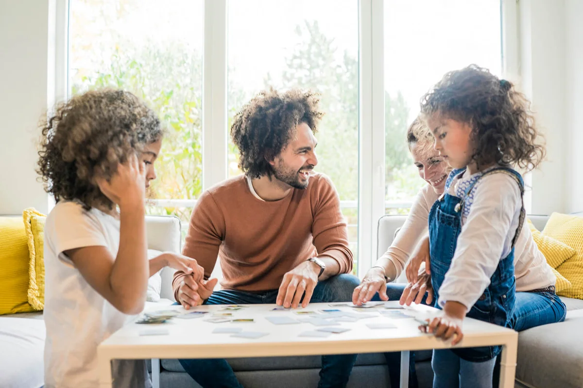Family sitting on couch, playing game