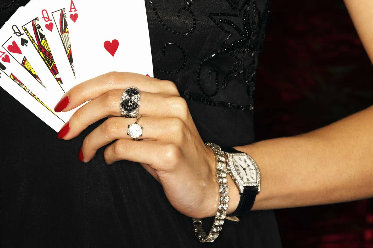 James Bond style woman holding playing cards
