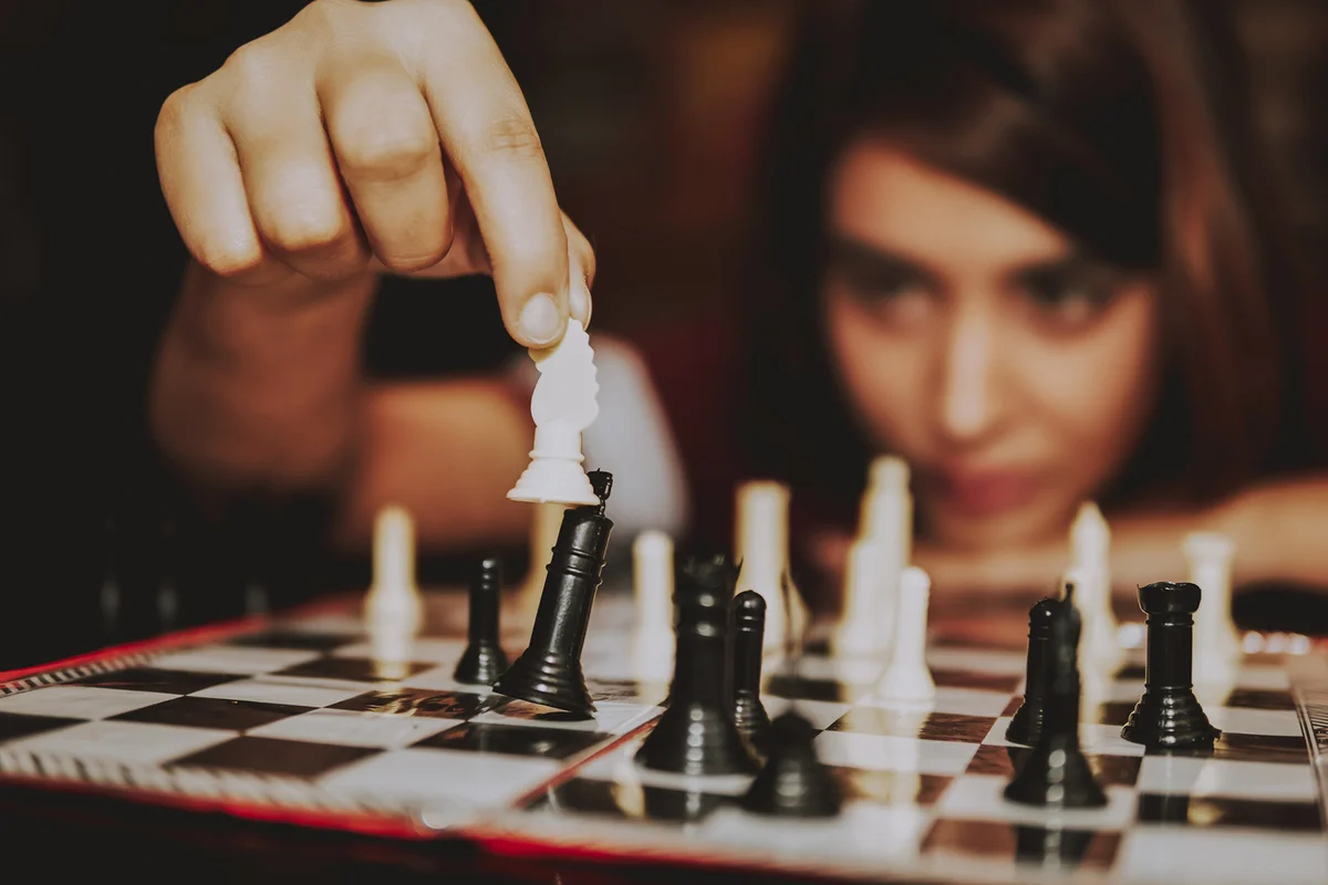 Young woman playing chess