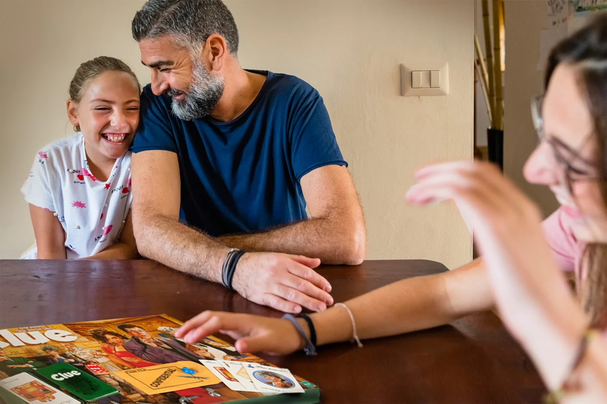 Family playing Clue game