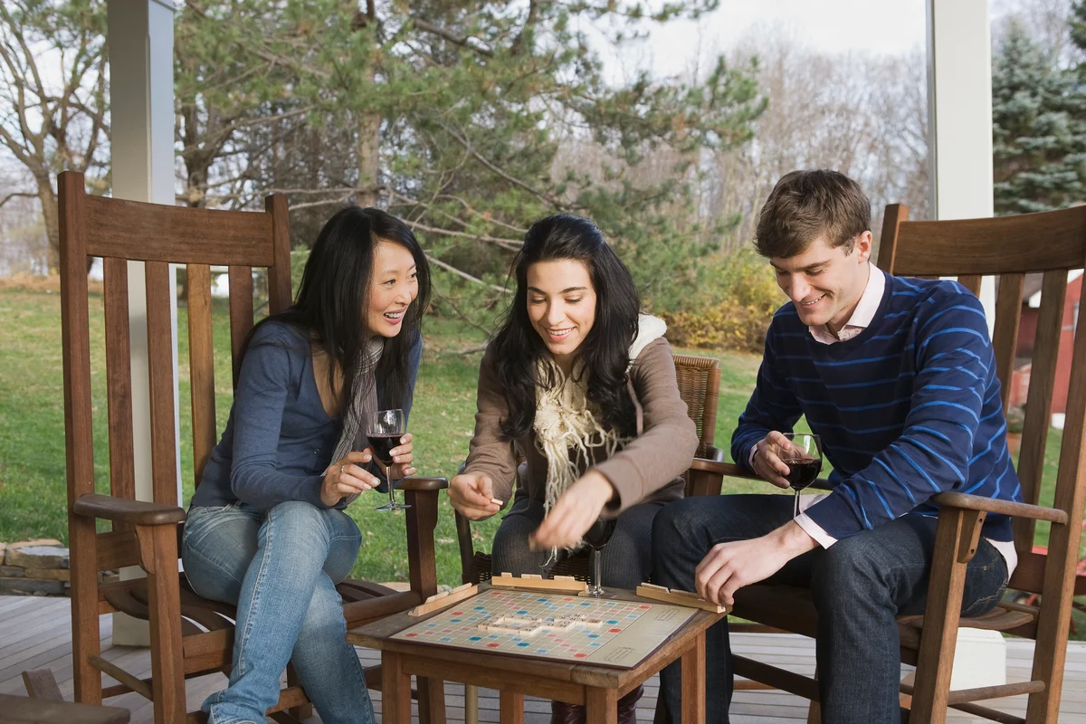 Friends playing scrabble on porch
