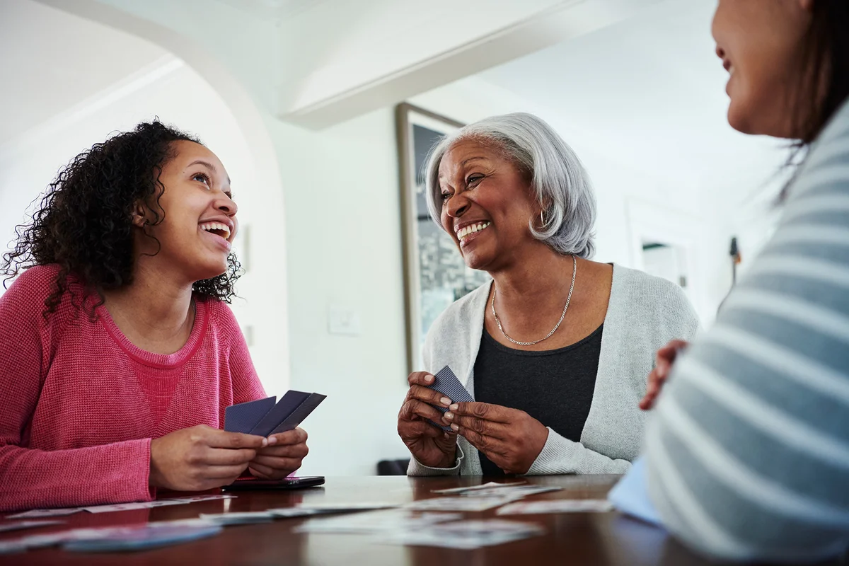grandmother playing Go Fish with family