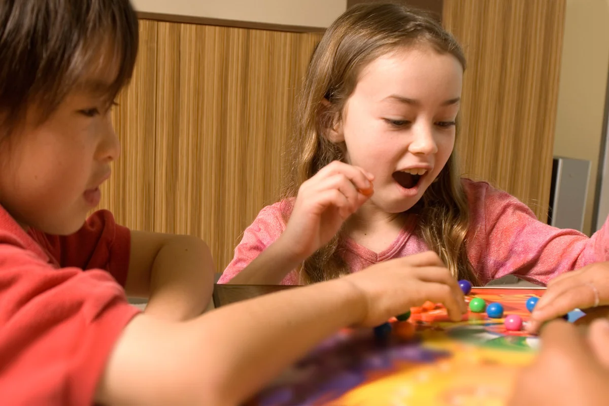 Kids playing marble board game