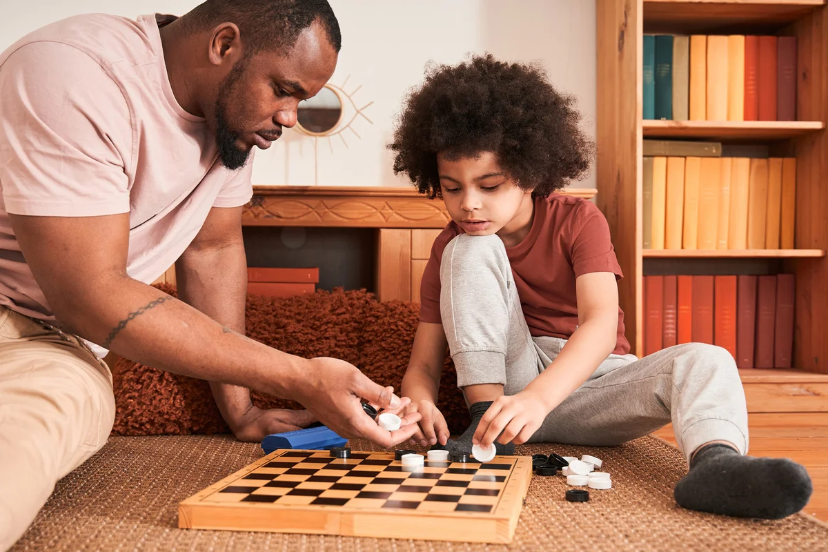 Father and son playing checkers