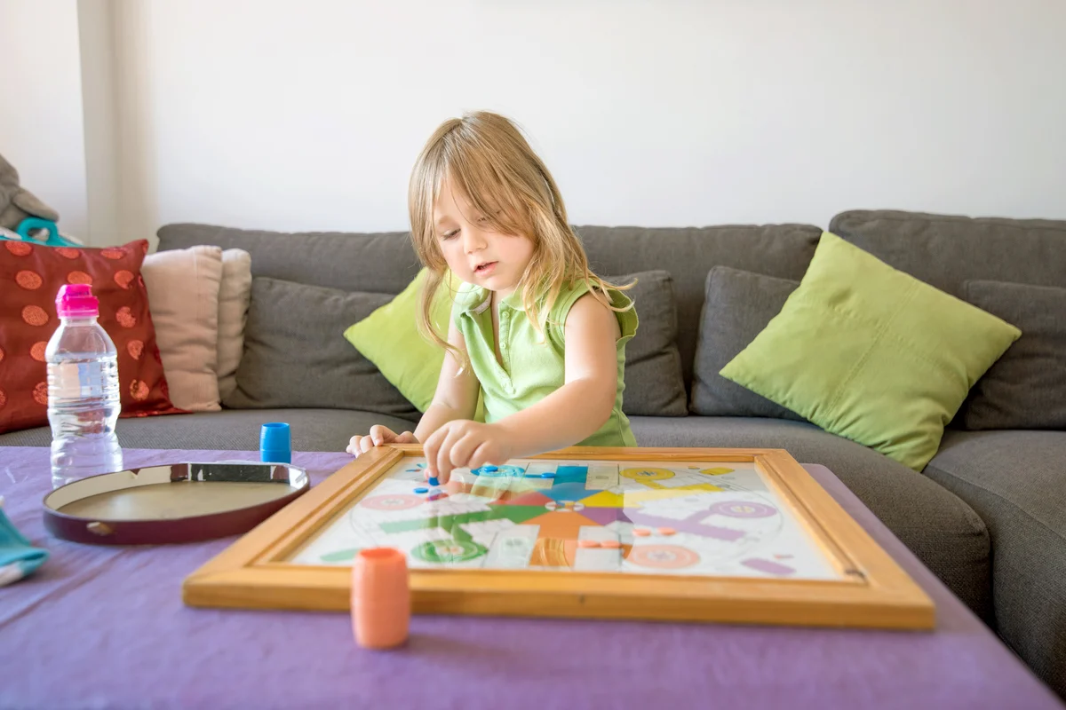 Child playing parcheesi game