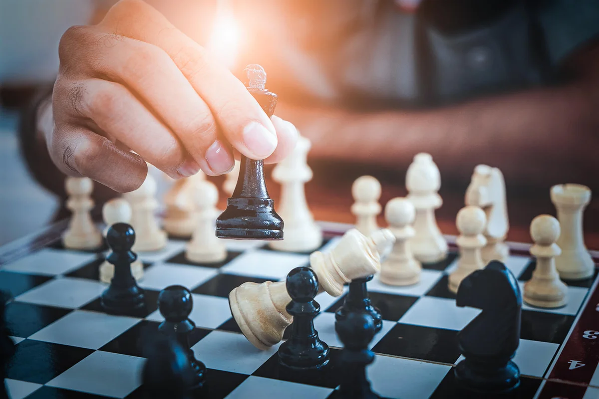 Hand of man playing chess game