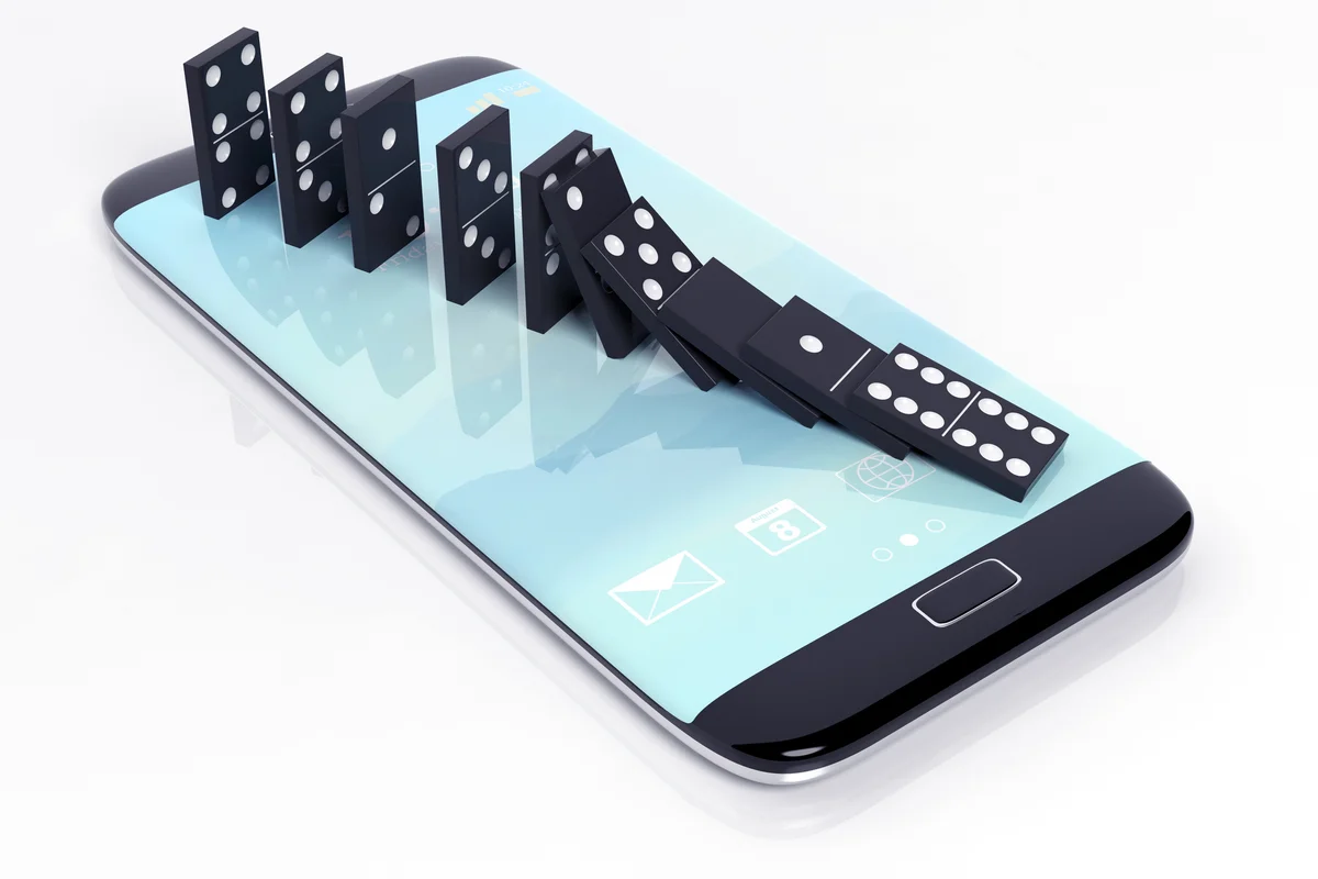 Black domino tiles falling in a row on smartphone screen