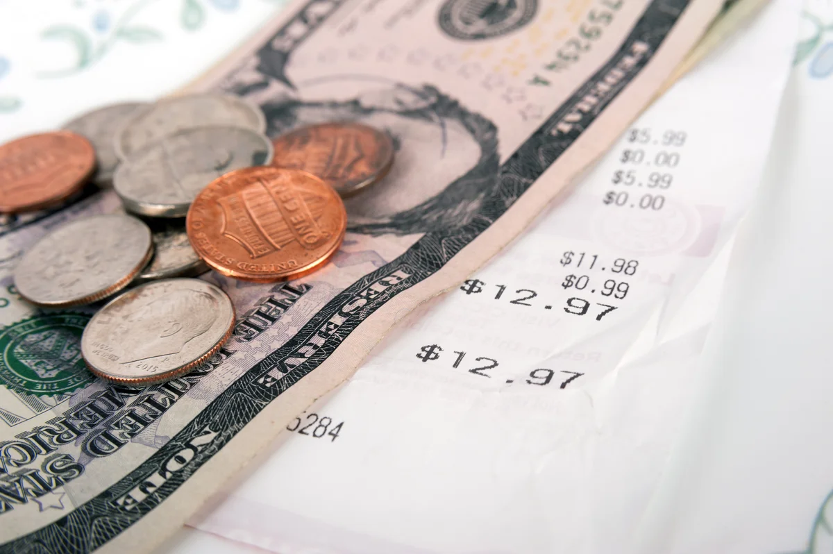 Restaurant bill with dollar bills