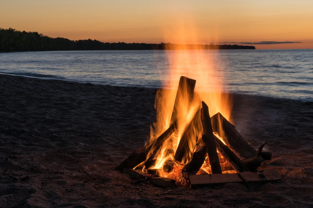 Blazing Bonfire on the Beach at Sunset